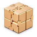 Luxury gold metallic infinity cube desk fidget toy folded on white backdrop
