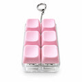 Sakura pink 6-key mechanical keyboard fidget keychain on white studio backdrop