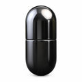 Obsidian black metal capsule fidget slider upright on studio background