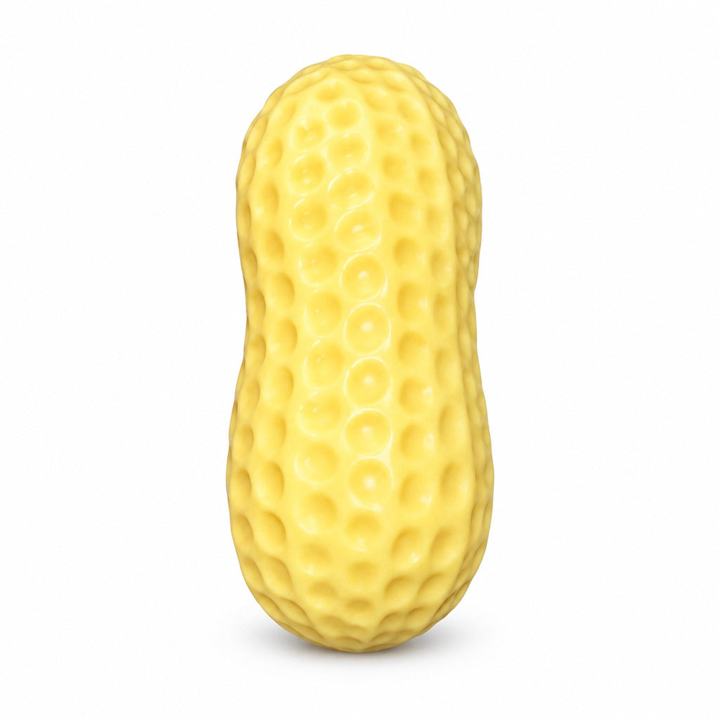Yellow textured peanut squishy toy standing upright on studio background