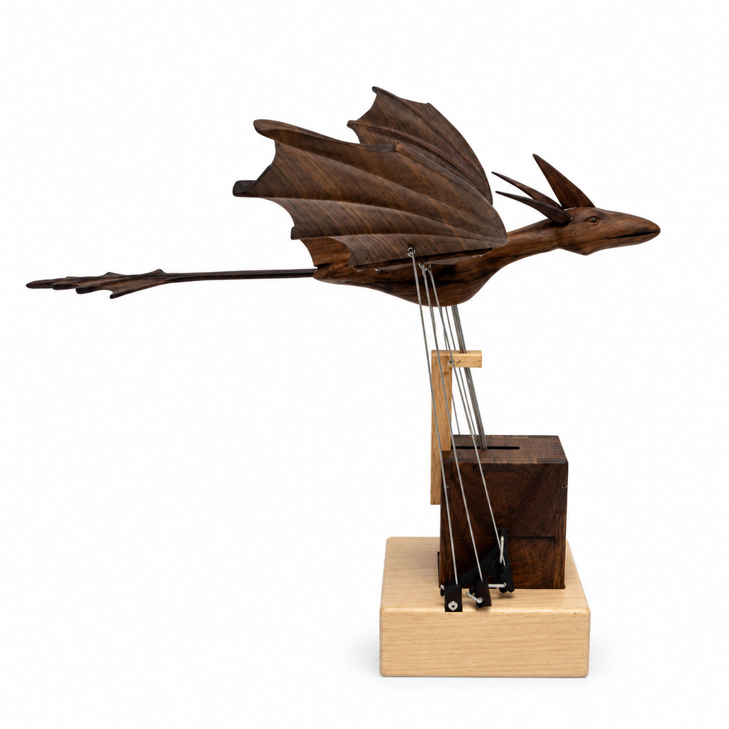 Side profile of kinetic dragon sculpture displaying push-rod linkage mechanism