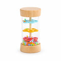 Small wooden rain stick toy with colorful beads and flower-shaped plates, isolated on a white background.